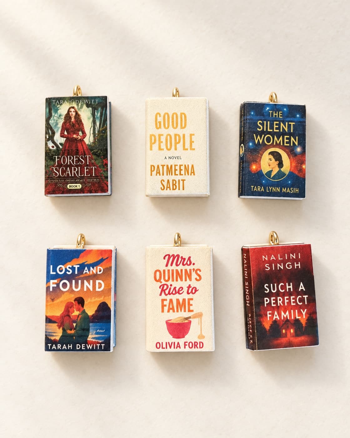 Six miniature book charms, each a tiny copy of a book cover