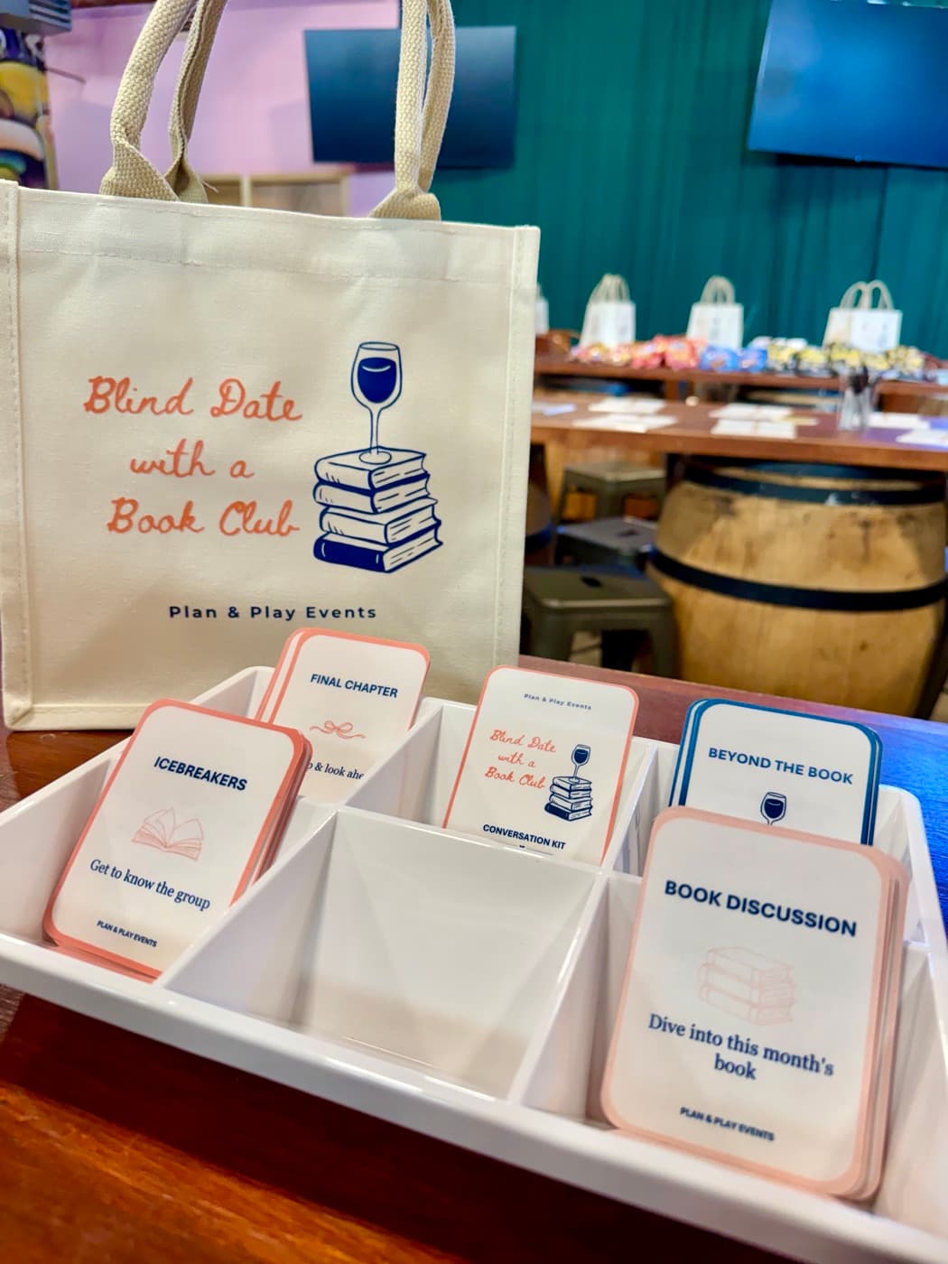 Blind Date with a Book Club tote bag next to a tray of conversation cards